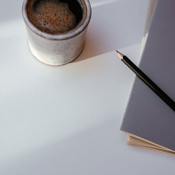 Calendar and a cup of coffee symbolizing a daily routine.